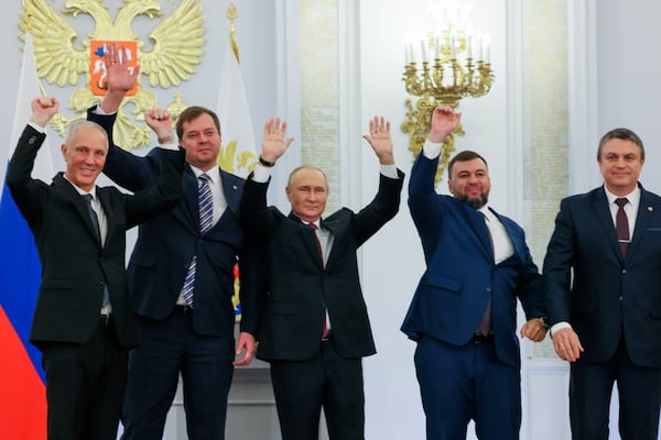 FILE - From left, Vladimir Saldo, Yevgeny Balitsky, Vladimir Putin, center, Denis Pushilin and Leonid Pasechnik wave during a Kremlin ceremony on Sept. 30, 2022, for Russia to annex four regions of Ukraine that it seized at the Kremlin in Moscow. (Mikhail Metzel, Sputnik, Kremlin Pool Photo via AP, File)
