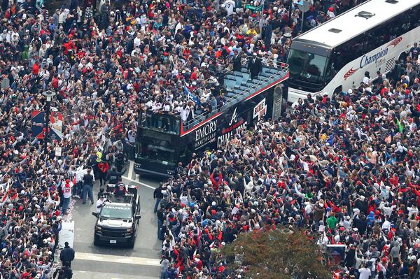 110521 ATLANTA: Braves players hoist the Commissioner's Trophy from the top of a double decker bus surrounded by thousands of fans as they arrive in the Battery outside Truist Park while the Atlanta Braves host a World Series Championship Parade and celebration on Friday, Nov. 5, 2021, in Atlanta.   “Curtis Compton / Curtis.Compton@ajc.com”