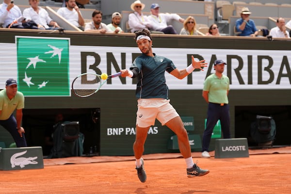 Italy's Lorenzo Musetti plays a shot against Frances Tiafoe of the U.S. during their quarterfinal match of the French Tennis Open at the Roland-Garros stadium in Paris, Tuesday, June 3, 2025. (AP Photo/Aurelien Morissard)