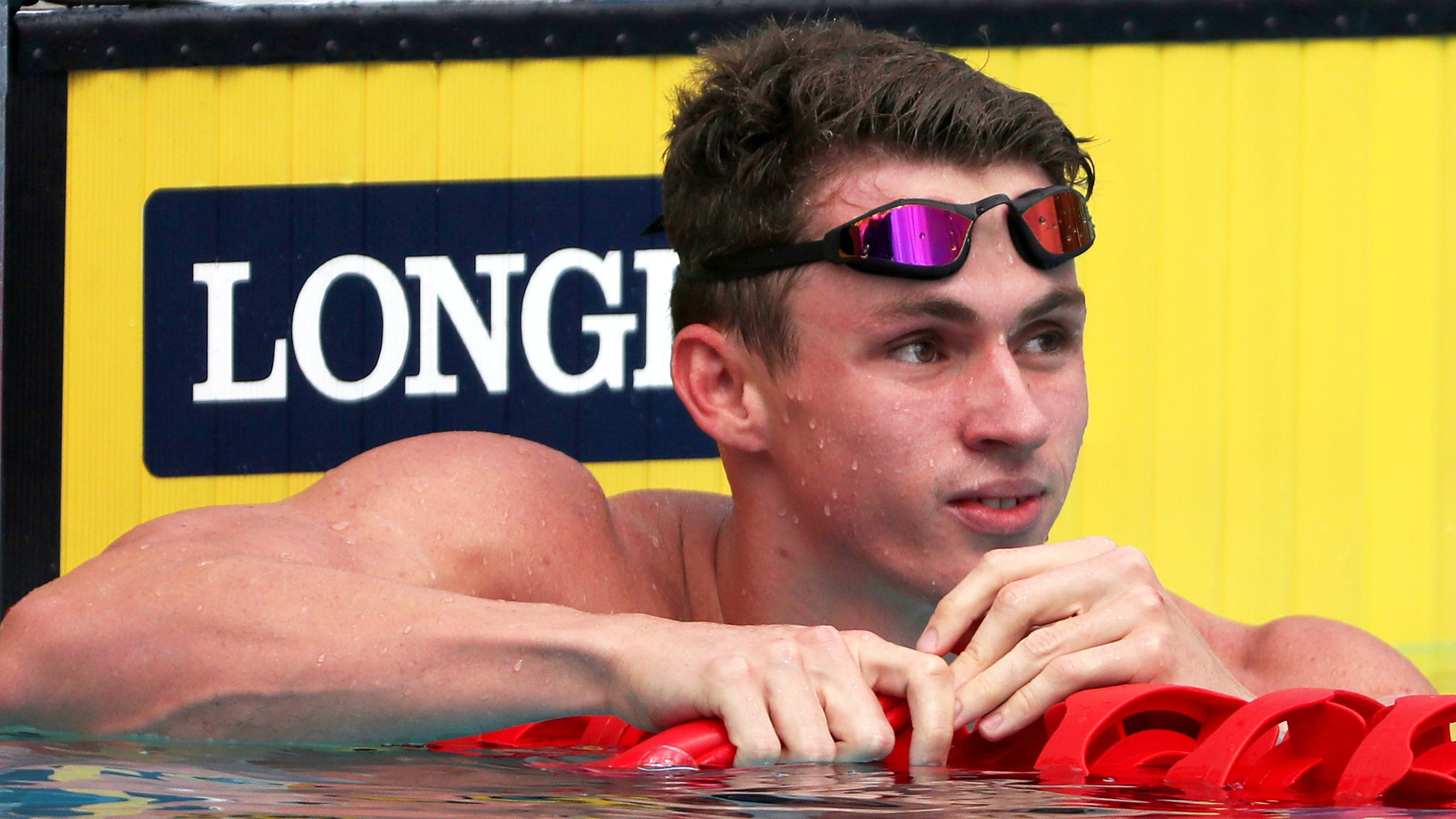 FILE - England's Ben Proud reacts after he was disqualified in his men's 50m butterfly heat during the 2018 Commonwealth Games at the Aquatic Centre on the Gold Coast, Australia, April 5, 2018. (AP Photo/Rick Rycroft, File)