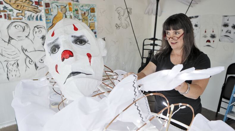 Chantelle Rytter works on one of her super-sized street puppets, this one a replica of Puddles Pity Party, the singing clown, in her Midtown studio. BOB ANDRES /BANDRES@AJC.COM