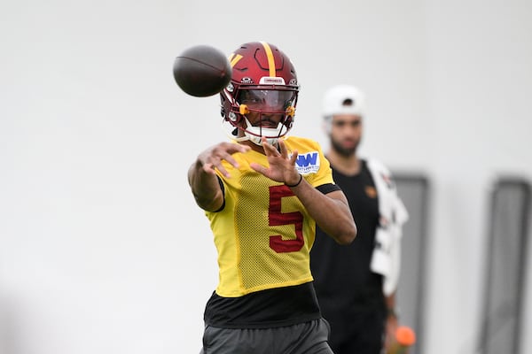 Washington Commanders quarterback Jayden Daniels works out during NFL football practice, Wednesday, May 28, 2025, in Ashburn, Va. (AP Photo/Nick Wass)