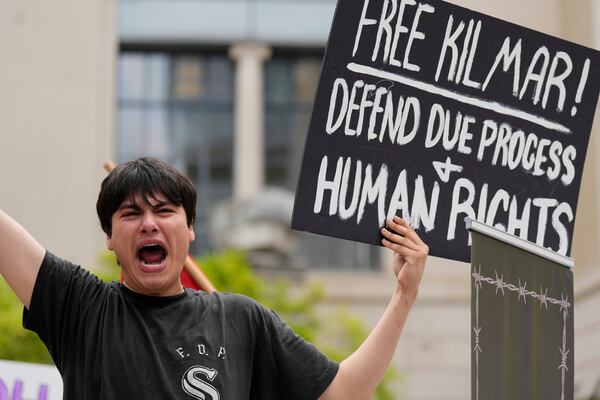 Tiki Osiris holds a sign as protesters gather outside the Federal Courthouse before arguments whether Kilmar Abrego Garcia can be released from jail on Friday, June 13, 2025 in Nashville, Tenn. (AP Photo/George Walker IV)