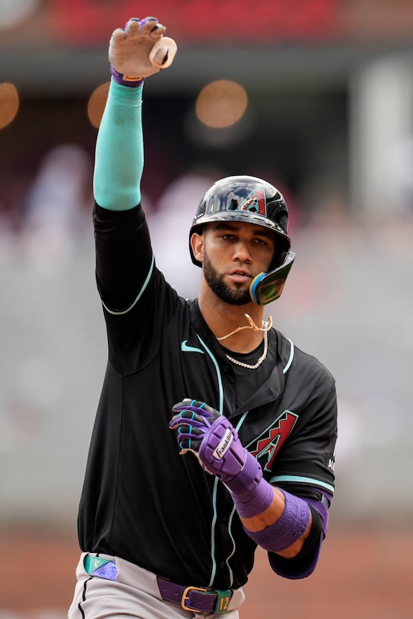 Arizona Diamondbacks outfielder Lourdes Gurriel Jr. (12) celebrates his solo homer against the Atlanta Braves in the eighth inning of a baseball game, Thursday, June 5, 2025, in Atlanta. (AP Photo/Mike Stewart)