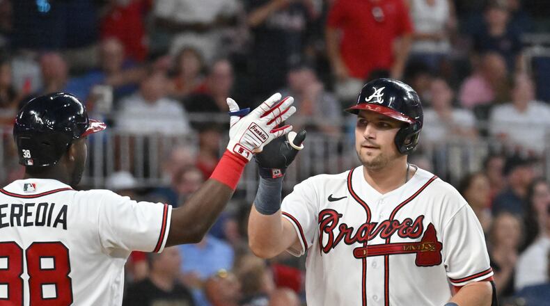Atlanta Braves' third baseman Austin Riley (27) celebrates after hitting a two-run home run to score Dansby Swanson in the fourth inning at Truist Park on Saturday, July 23, 2022. (Hyosub Shin / Hyosub.Shin@ajc.com)