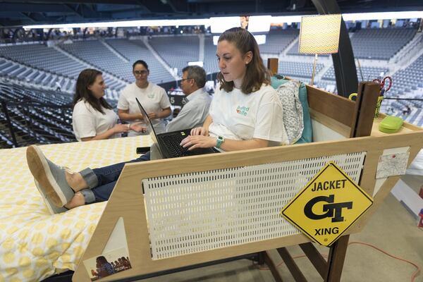  Natalie Larkins, a fourth year industrial design student at Georgia Tech, sits in her group’s demonstration bed during their presentation at the Capstone Expo. (DAVID BARNES / DAVID.BARNES@AJC.COM)