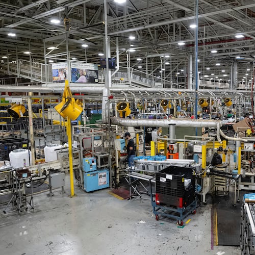 FILE - Employees piece together components on an assembly line at GE Appliances global headquarters, Aug 13, 2025, in Louisville, Ky. (AP Photo/Jon Cherry, file)