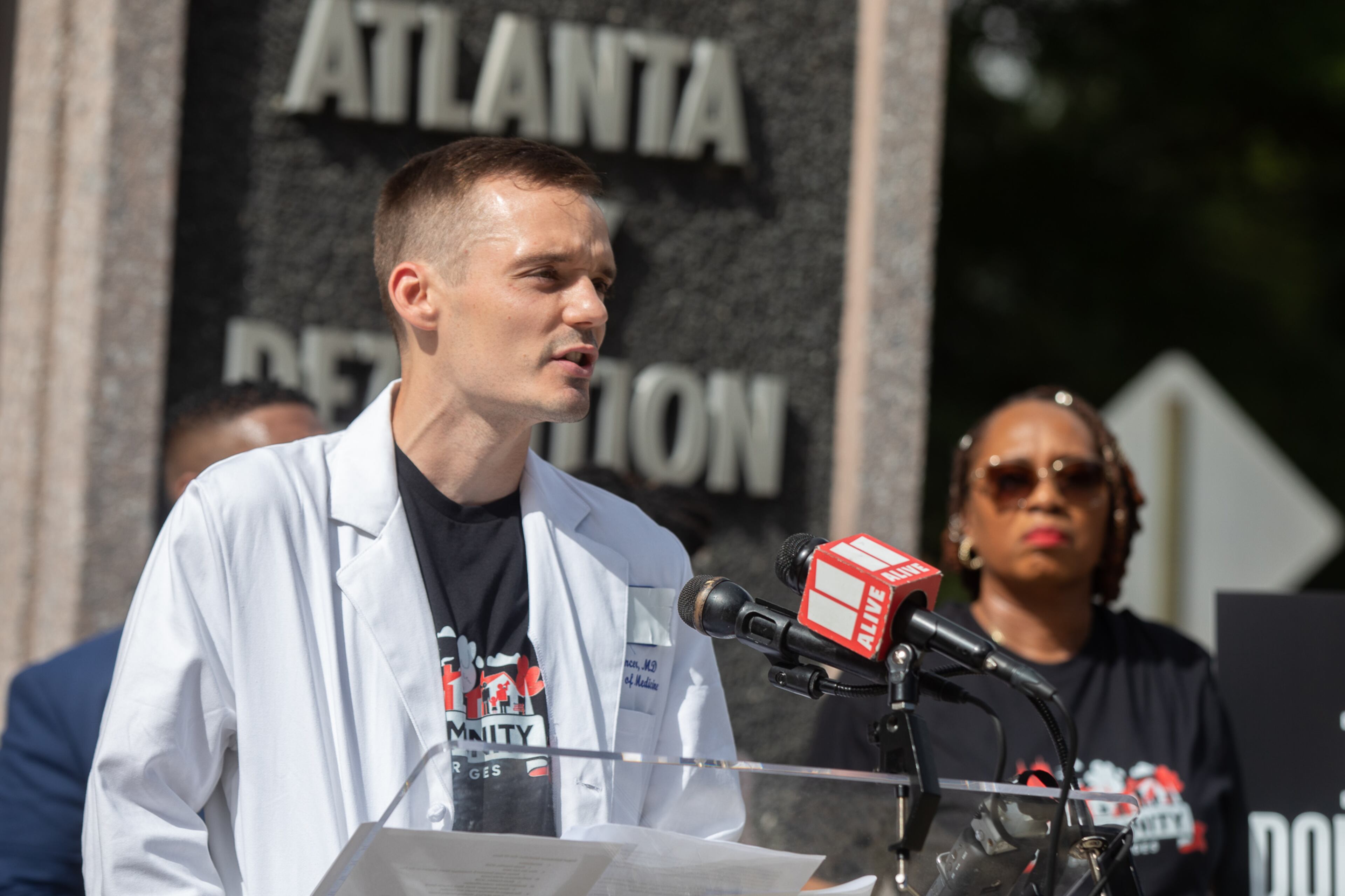 Dr. Mark Spencer, an internal medicine physician in Atlanta and executive director of Stop Criminalization Of Our Patients, speaks alongside advocates as they call for the withdrawal of Fulton County inmates from Atlanta's city jail on Aug. 13, 2025. (Riley Bunch/AJC)