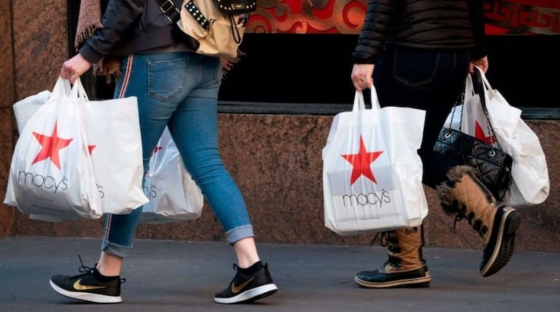 Shoppers walk outside the Macy's store at Manhattan's Herald Square in New York. Photo by Don EMMERT / AFP/Getty Images.