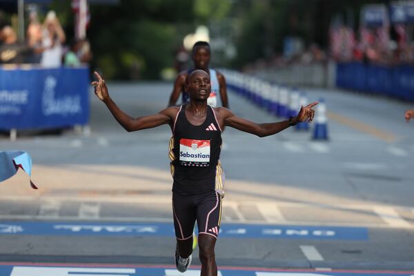 Elite men’s winner Sabastian Sawe crosses the finish line of the 55th running of the Atlanta Journal-Constitution Peachtree Road Race in Atlanta on Thursday, July 4, 2024.   (Jason Getz / AJC)