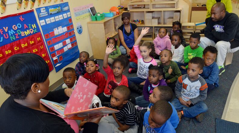 Teacher Natunya Brown reads a story to pre-K students after their naptime Wednesday. Lead teacher James Hollifield and assistant Carletta Johnson listen in. Georgia's popular, lottery funded pre-kindergarten program is paying off for 4-year-olds, giving them a leg-up on counting and six other skills they need for school, according to a study released on Wednesday. Researchers at UNC Chapel Hill's Frank Porter Graham Child Development Institute found students who completed Georgia pre-k and were headed to kindergarten performed better on seven of 10 school readiness skills than students of the same age who were just entering the program.