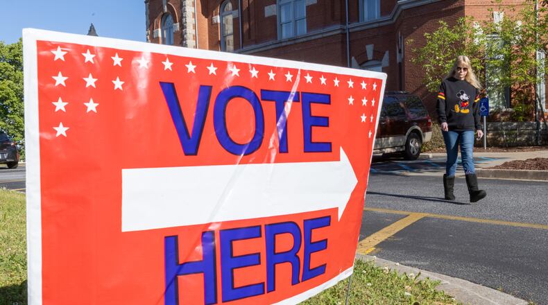 Gwen Davis walks back to her car after casting her vote at the Clayton County Courthouse Tuesday, April 18, 2023  (Steve Schaefer/steve.schaefer@ajc.com)