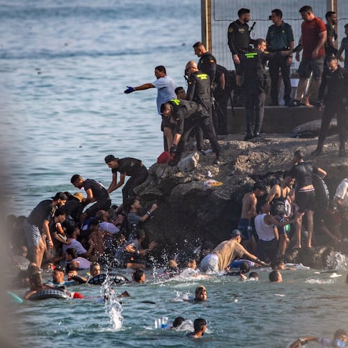 Migrants try to cross from Morocco into the Spanish enclave of Ceuta, Thursday, July 30, 2026. (AP Photo/Antonio Sempere)