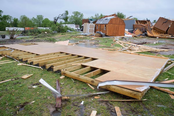 Broken sheds, lumber, and walls lie strewn on the ground behind Quality Inn, Sunday, April 20, 2025 in Ada, Okla. (Richard R. Barron/The Ada News via AP)