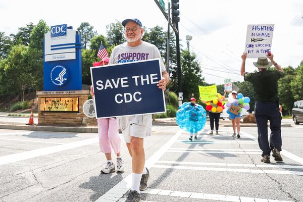 Protestors hold signs outside of the CDC in Atlanta on Wednesday, June 25, 2025. As Health and Human Services Secretary Robert F. Kennedy Jr. purged and reconstituted CDC vaccine advisory panel, ACIP, convenes for the first time, CDC advocates gather to protest on the dangers to health. (Abbey Cutrer / AJC)