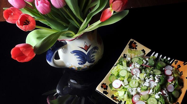 Tulips adorn a table with a spring salad with spinach, romaine lettuce, radish and cucumber, served with a creamy mint dressing. (Nate Guidry/Pittsburgh Post-Gazette/TNS)