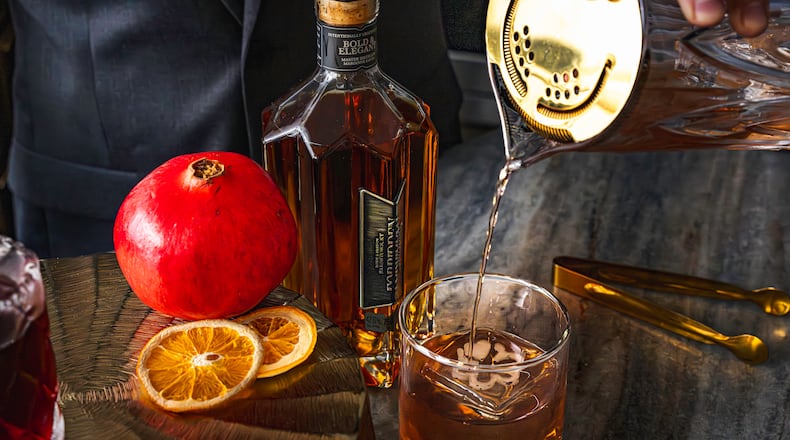 Vegas Placas, lead mixologist for the Loft at Soby’s New South Cuisine, pours a Forbidden Fruit Fashion. Placas created the signature cocktail for the Michelin Guide American South ceremony on Monday, Nov. 3, 2025, in Greenville, South Carolina. (Courtesy of Ariel Madison/Table 301)