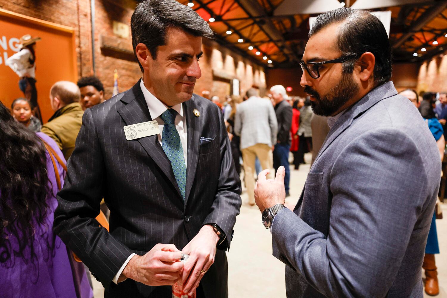 House Majority Leader Chuck Efstration (left), R-Mulberry, speaks with Jaime Rangel, of immigrant advocacy group FWD.us, at the supper. (Miguel Martinez/AJC)
