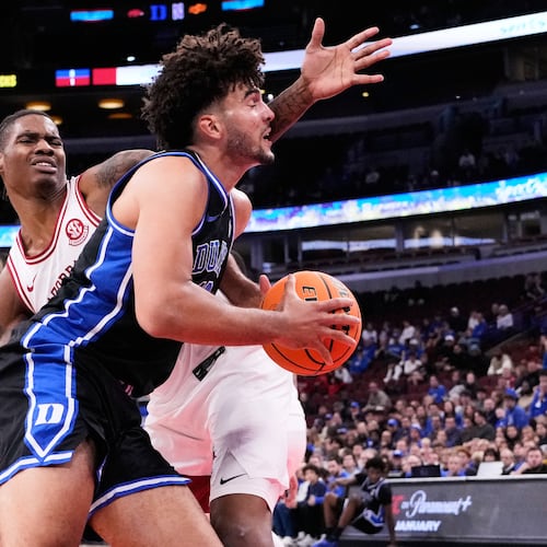 Duke forward Cameron Boozer, right, drives to the basket as Arkansas forward Nick Pringle, left, defends during the first half of an NCAA college basketball game in the CBS Sports Thanksgiving Classic tournament Thursday, Nov. 27, 2025, in Chicago. (AP Photo/Nam Y. Huh)