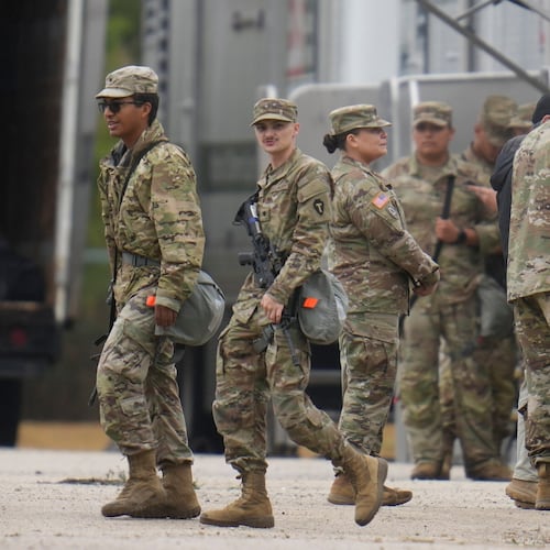 Military personnel in uniform, with the Texas National Guard patch on, are seen at the U.S. Army Reserve Center, Tuesday, Oct. 7, 2025, in Elwood, Ill., a suburb of Chicago. (AP Photo/Erin Hooley)