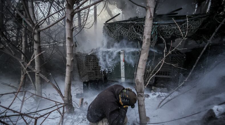 In this photo provided by Ukraine's 24th Mechanized Brigade press service, servicemen fire a 2S1 Gvozdika self propelled howitzer towards Russian positions near Chasiv Yar town, Donetsk region, Ukraine, Sunday, Jan. 18, 2026. (Oleg Petrasiuk/Ukraine's 24th Mechanized Brigade via AP)