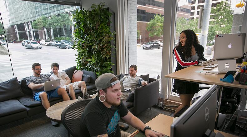 (USE THIS PHOTO LEAD) A new wave of technology companies are moving into and expanding in downtown, including Austin software maker Bigcommerce which has office space at 800 Brazos St. at E. 8th St. Nina Blanson, a software engineer working Thursday afternoon May 12, 2016, is one of the employees who was attracted to working downtown. Branson, far right, talks with fellow workers from left, Jason Schmitt, Engineering Manager, Chris Marconi, Software Engineer, Tyler Pouchot, Marketplace Coorindator, foreground, Nate Stewart,Product Manager. 
RALPH BARRERA/AMERICAN-STATESMAN