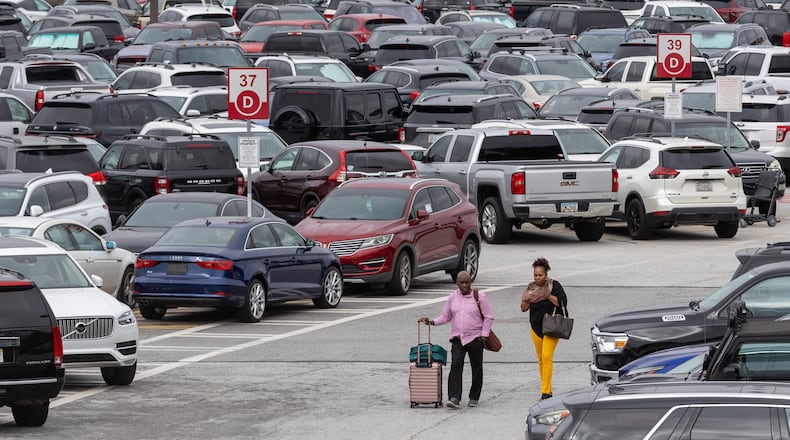 Travelers walk through the South economy lot at Hartsfield-Jackson Atlanta International Airport on Thursday, Sept. 28, 2023. (Steve Schaefer/steve.schaefer@ajc.com)