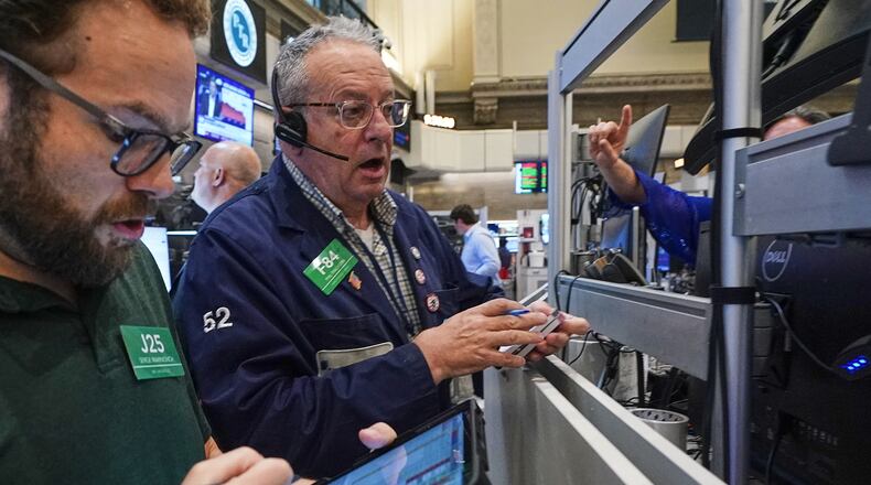 Options traders Serge Marinovich, left, and Phil Phil Fracassini work on the floor of the New York Stock Exchange, Friday, June 26, 2026. (AP Photo/Richard Drew)