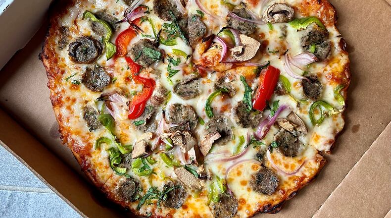 The seekh kabab sausage pizza from Tandoori Pizza and Wings is a must-try. Henri Hollis/henri.hollis@ajc.com