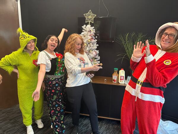 Dressed for the occasion, Taylor Scott (left) and Kevin Avery (right) herald the arrival of Christmas on Nov. 26, 2025, on Star 94.1 with producer Alyssa DiTomasso (second to left) and their boss Emily Boldon. (Rodney Ho/AJC) 