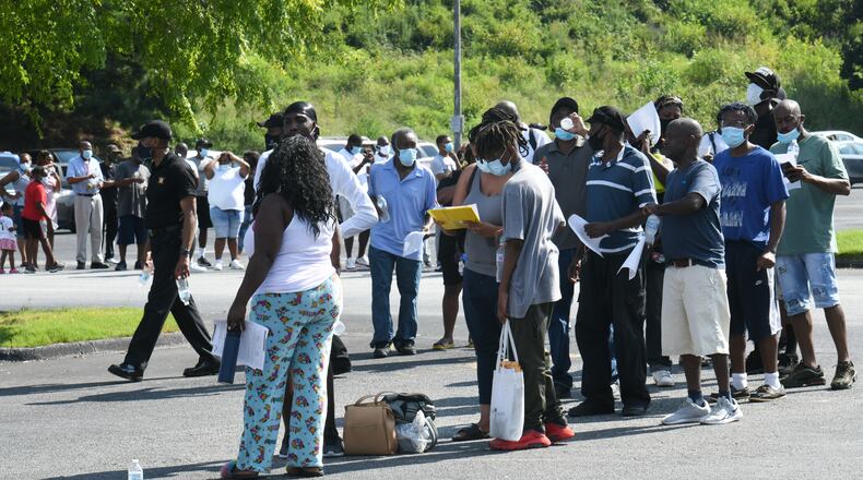 DeKalb County residents line up to receive a COVID-19 vaccine -- and a $100 prepaid debit card -- during an event at The Gallery at South DeKalb on Saturday, Aug. 13. The county is holding a similar event Saturday, Aug. 28 at Stonecrest Mall. (Hyosub Shin / Hyosub.Shin@ajc.com)