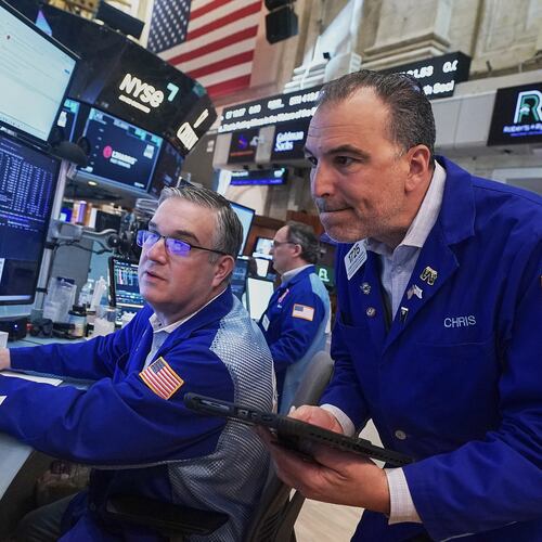 Traders Jim Bodner, left, and Chris Lagana work on the floor of the New York Stock Exchange, Thursday, April 23, 2026. (AP Photo/Richard Drew)