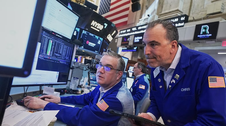 Traders Jim Bodner, left, and Chris Lagana work on the floor of the New York Stock Exchange, Thursday, April 23, 2026. (AP Photo/Richard Drew)
