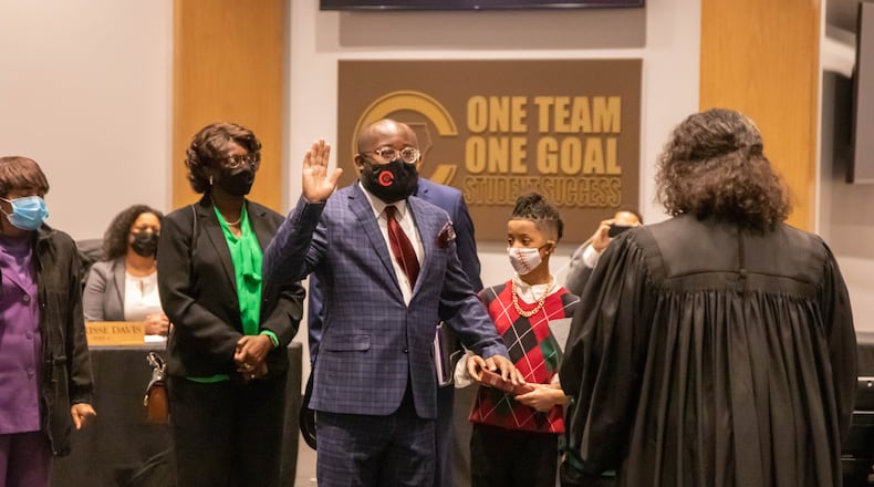 New Cobb County Board of Education member Leroy "Tre" Hutchins takes his oath of office issued by Superior Court Judge Kellie Hill during a called meeting on Thursday. Credit: Cobb County School District.