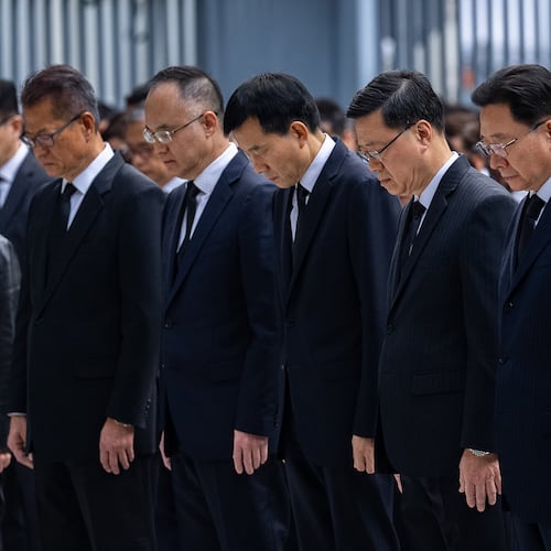 Hong Kong Chief Executive John lee, center and other officers observe a moment of silence for the victims of the deadly fire that started Wednesday at Wang Fuk Court, a residential estate in the Tai Po district of Hong Kong's New Territories, Saturday, Nov. 29, 2025. (AP Photo/Chan Long Hei)
