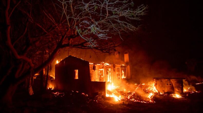 Flames consume a home on N. Fairview Ave. as the Holiday fire burns in Goleta, Calif., on Saturday, July 7, 2018. The blaze has destroyed multiple homes. (AP Photo/Noah Berger)