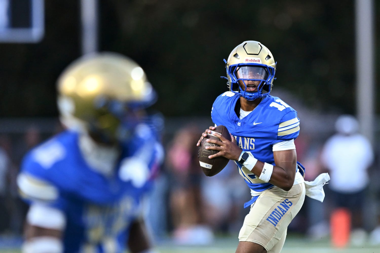 McEachern quarterback Calvin Pittman Jr (12) looks for a receiver during the first half of play Friday, August 22, 2025 at McEachern.  (Daniel Varnado/For the Atlanta Journal-Constitution)
