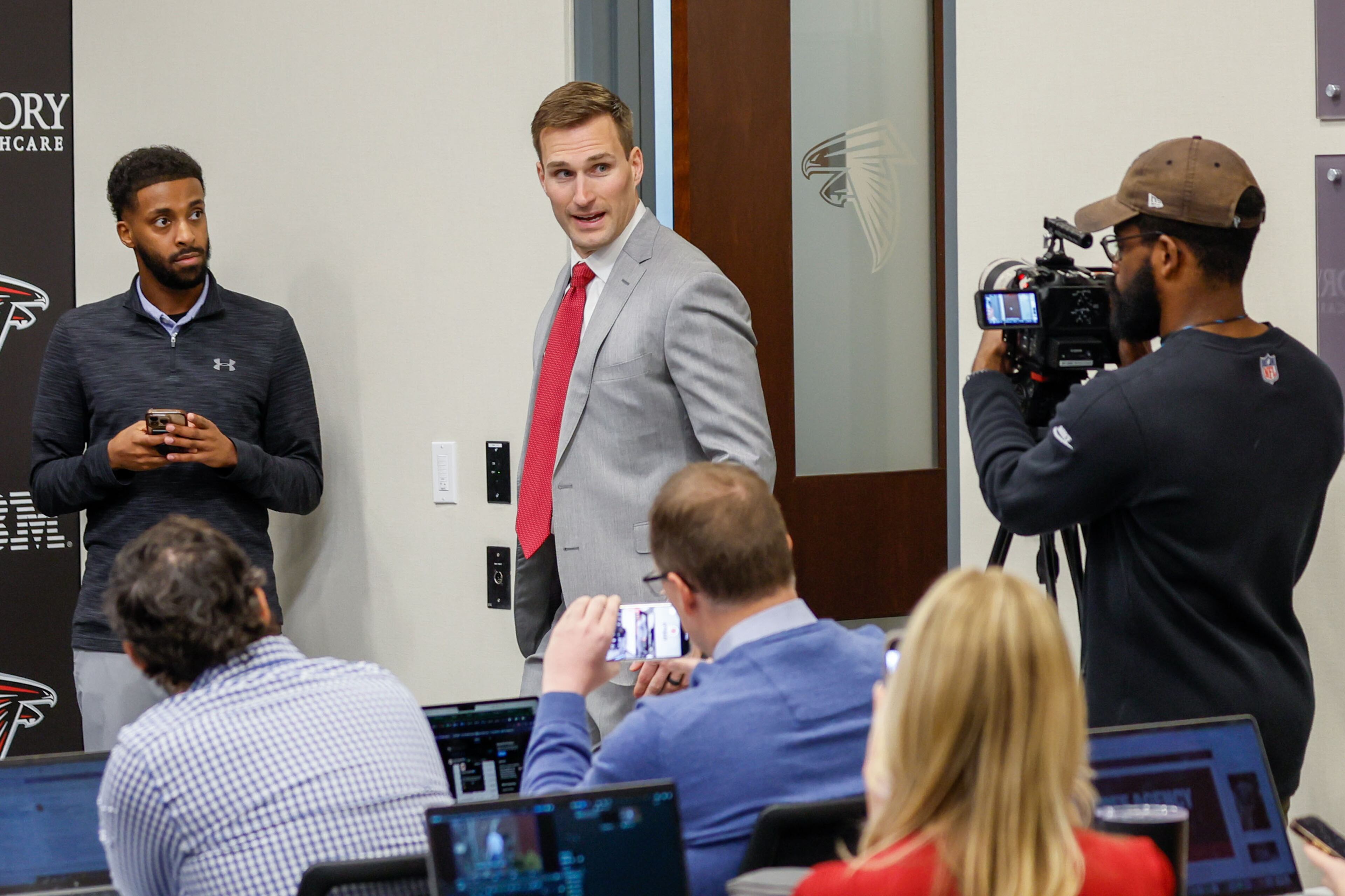 Kirk Cousins greets members of the press as he walks into the media room during his introductory news conference on March 13, 2024. (Miguel Martinez/AJC)
