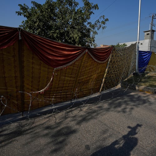 Police personnel stand guard at a cordoned-off road near the site of Tuesday's suicide bombing outside the gates of a district court, in Islamabad, Pakistan, Wednesday, Nov. 12, 2025. (AP Photo/Anjum Naveed)