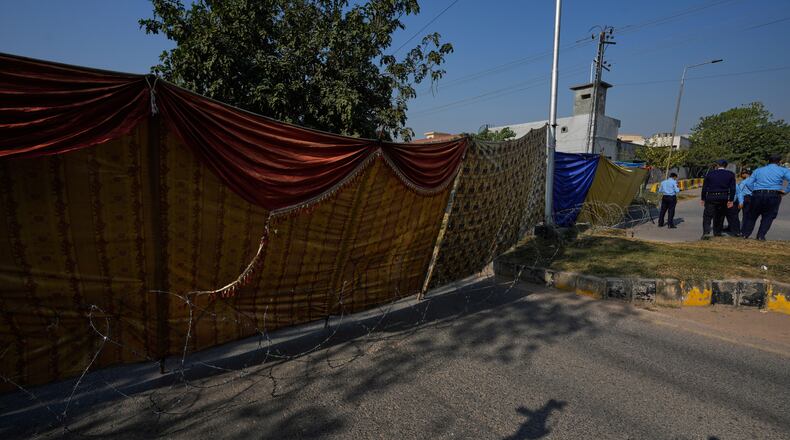 Police personnel stand guard at a cordoned-off road near the site of Tuesday's suicide bombing outside the gates of a district court, in Islamabad, Pakistan, Wednesday, Nov. 12, 2025. (AP Photo/Anjum Naveed)
