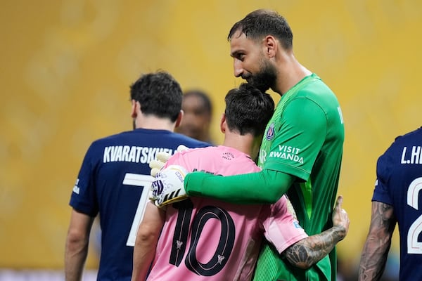 Paris Saint-Germain's goalkeeper Gianluigi Donnarumma embraces Inter Miami's Lionel Messi after the Club World Cup round of 16 soccer match between PSG and Inter Miami in Atlanta, Sunday, June 29, 2025. (AP Photo/Mike Stewart)