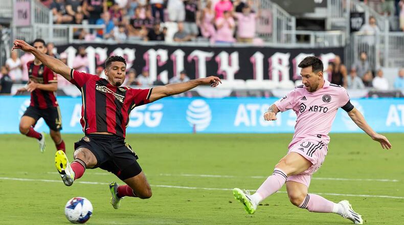Inter Miami's Lionel Messi (10) takes a first-half shot at goal as Atlanta United defender Miles Robinson (12) applies pressure during a Leagues Cup group stage match at DRV PNK Stadium on Tuesday, July 25, 2023, in Fort Lauderdale, Florida. (Matias J. Ocner/Miami Herald/TNS)