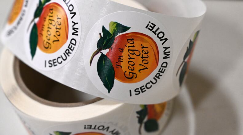 Voters who are at least 75 years old or who have a disability and require assistance to vote are allowed to take the next available voting compartment or booth without having to wait in line, according to Georgia law. (Hyosub Shin/AJC)