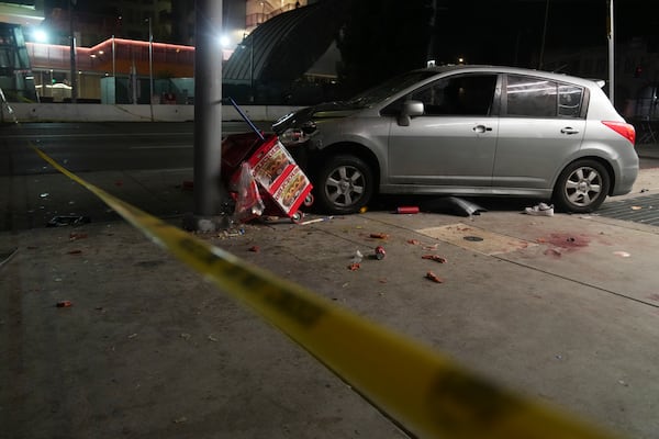 A vehicle sits on the sidewalk after ramming into a crowd of people waiting to enter a nightclub along a busy boulevard in Los Angeles early Saturday, July 19, 2025 injuring several people. (AP Photo/Damian Dovarganes)