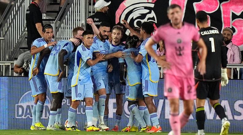 Atlanta United players celebrate after midfielder Saba Lobzhanidze, center, scored a goal against Inter Miami during the first half of an MLS soccer match Wednesday, May 29, 2024, in Fort Lauderdale, Fla. (AP Photo/Lynne Sladky)