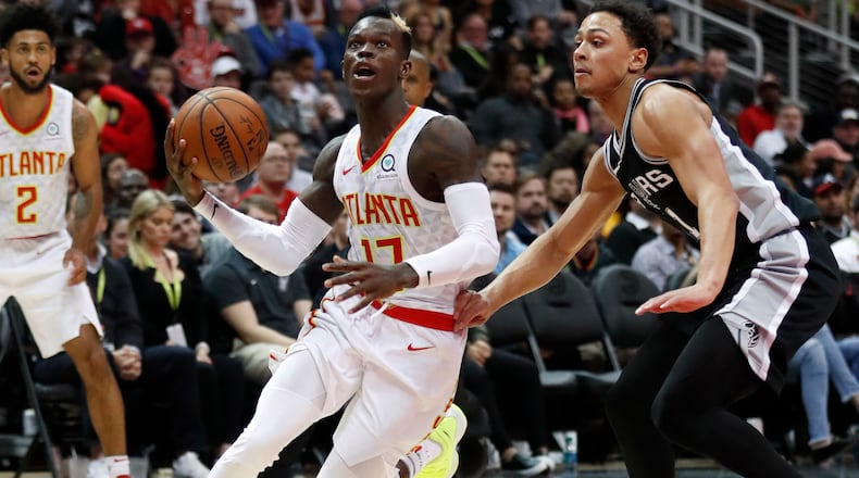 Atlanta Hawks guard Dennis Schroder (17) drives past San Antonio Spurs forward Kyle Anderson (1) as he goes to the basket in the second half of an NBA basketball game Monday, Jan. 15, 2018, in Atlanta. The Hawks won 102-99. (AP Photo/John Bazemore)