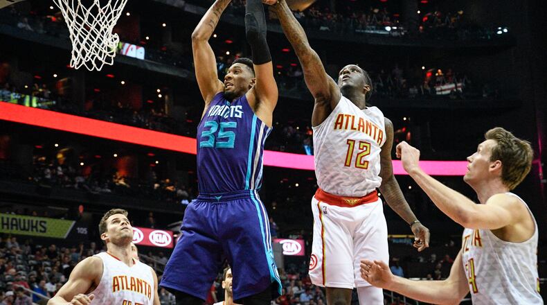 Charlotte Hornets forward Christian Wood (35) and Atlanta Hawks forward Taurean Prince (12) vie for a rebound during an NBA basketball game, Tuesday, April 11, 2017, in Atlanta. (AP Photo/John Amis)