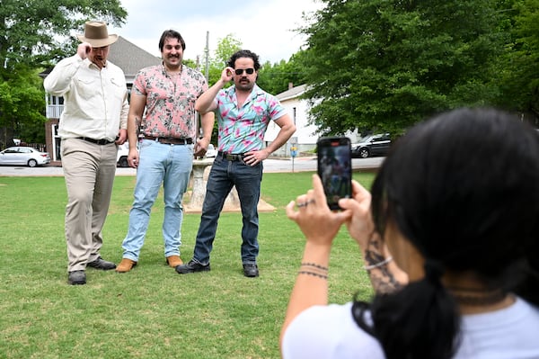 Trevor Rogers (from left), Brian O’Connor and Stephen Rouse pose for photos during a look-alike contest for actor David Harbour on May 4, 2025, at Cabbagetown Park in Atlanta. (Daniel Varnado/For the AJC)
