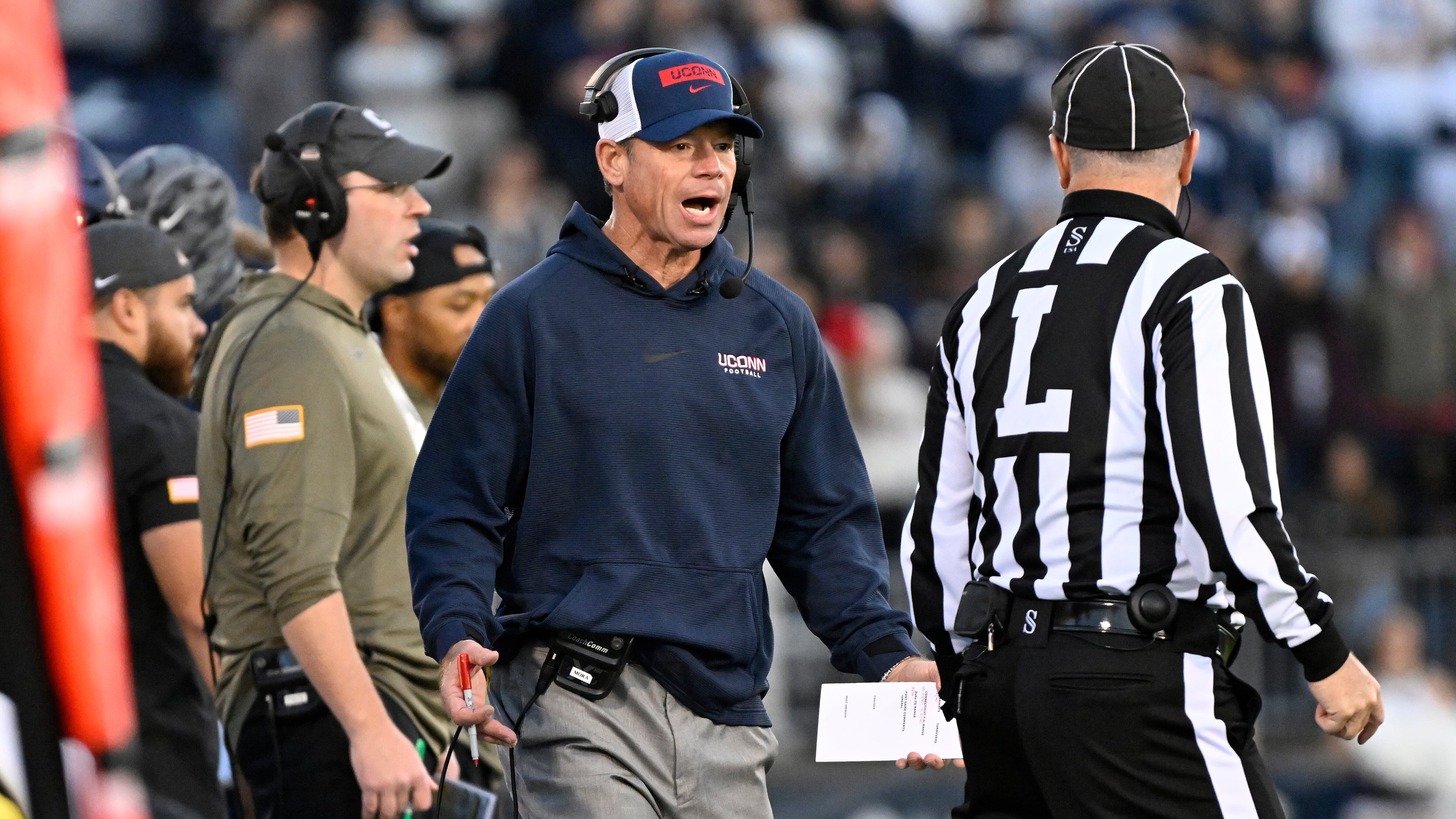UConn head coach Jim Mora talks with an official during the first half of an NCAA college football game against Duke, Saturday, Nov. 8, 2025, in East Hartford, Conn. (AP Photo/Jessica Hill)