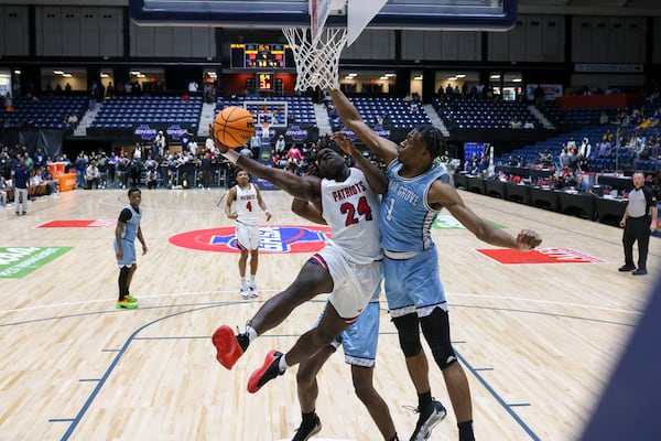 Sandy Creek guard Amari Latimer (left) attempts a shot against Cedar Grove forward Manny Green during the GHSA Boys 3A state championship at the Macon Centreplex on Wednesday, March, 5, 2025. Green has signed with Tennessee over other suitors. (Jason Getz/AJC 2025)